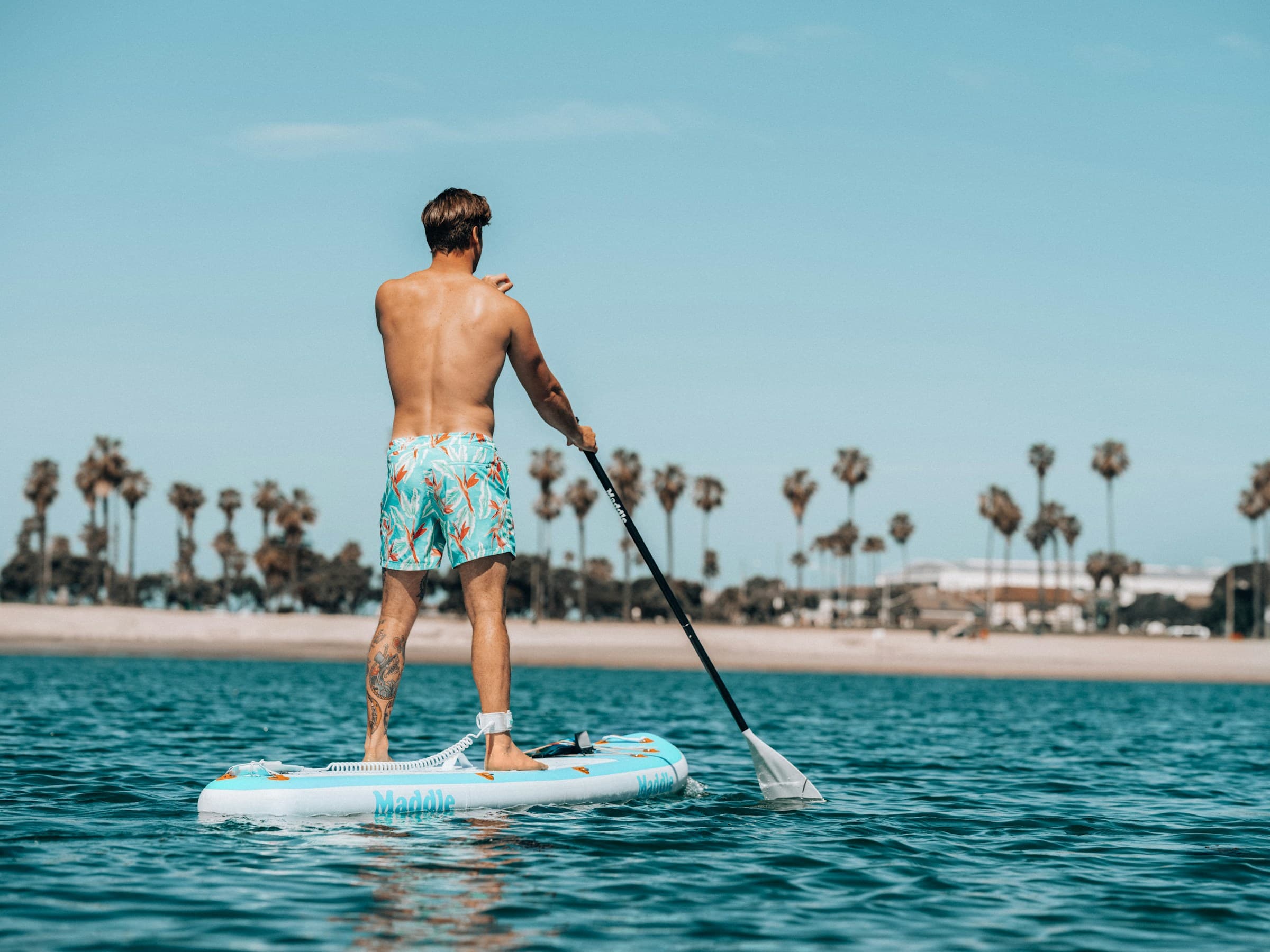 Surfer looking down carrying board